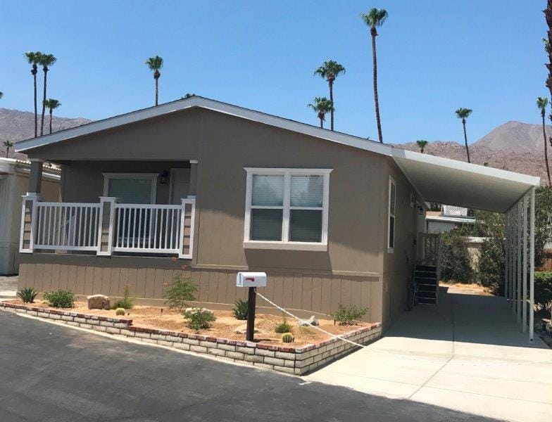 New manufactured home for sale with palm trees and mountain views at Silver Spur
